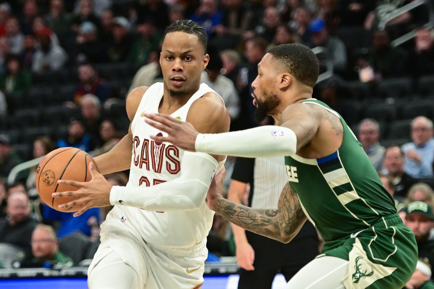 Jan 24, 2024; Milwaukee, Wisconsin, USA; Cleveland Cavaliers guard Isaac Okoro (35) drives for the basket against Milwaukee Bucks guard Damian Lillard (0) in the third quarter at Fiserv Forum. Mandatory Credit: Benny Sieu-USA TODAY Sports